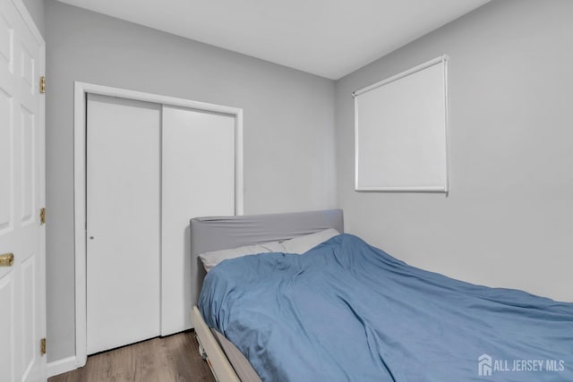 bedroom with a closet and wood finished floors