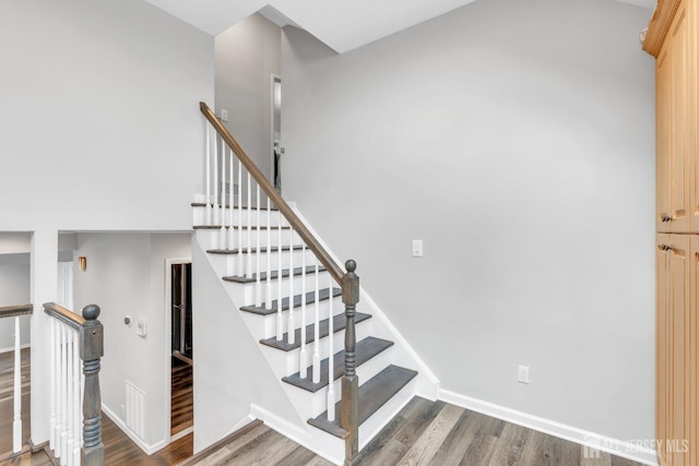stairs featuring baseboards and wood finished floors