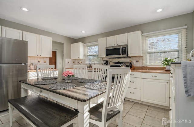 1565 W 6th St, Piscataway, NJ 08854 - kitchen featuring stainless steel appliances, white cabinets, decorative backsplash, and recessed lighting