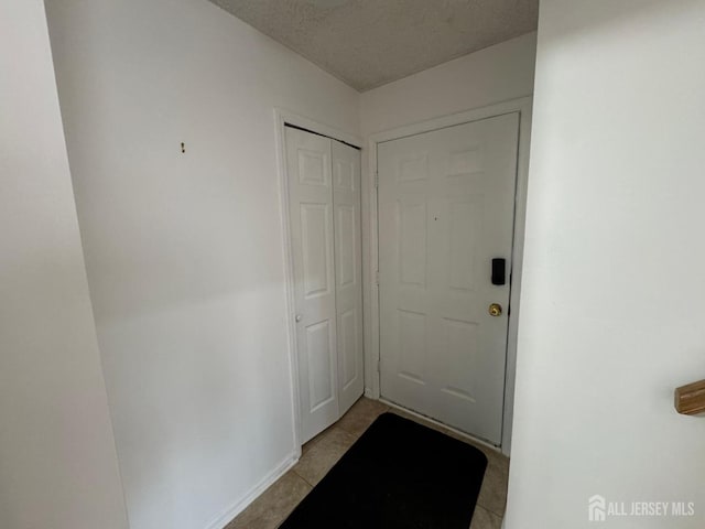 entryway featuring a textured ceiling