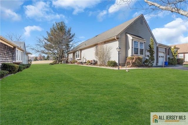 view of property exterior featuring a garage and a yard