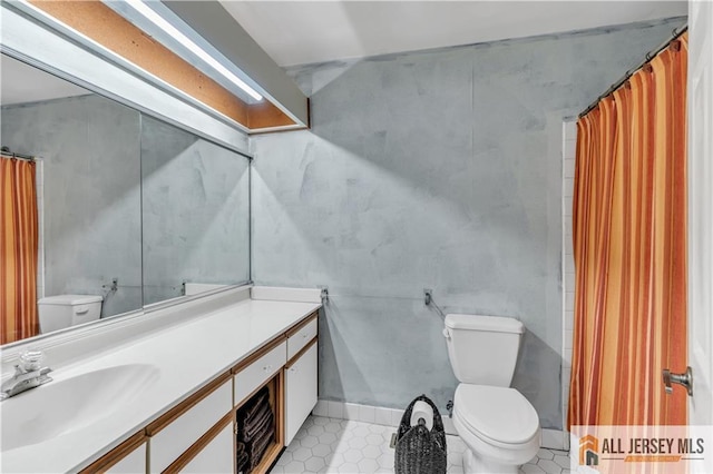 bathroom featuring vanity, tile patterned flooring, and toilet