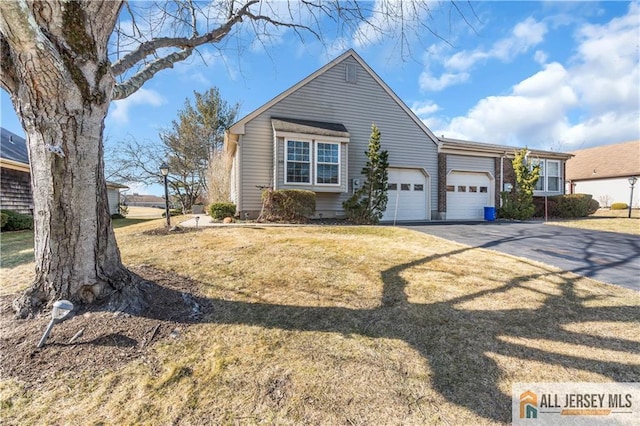 view of front of property with a front yard and a garage