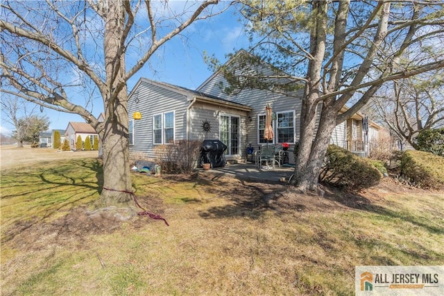 view of front of house with a patio and a front lawn