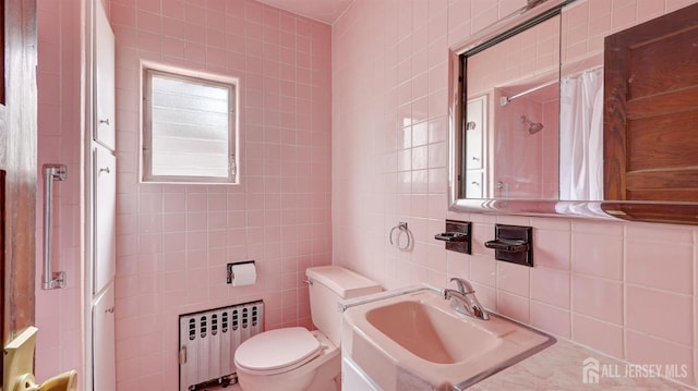 full bath featuring a shower with curtain, tile walls, a sink, toilet, and radiator heating unit