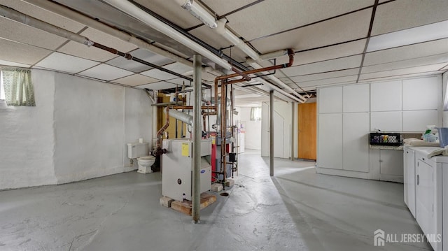 below grade area with separate washer and dryer and a heating unit