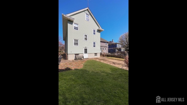 back of property featuring a patio area, fence, and a yard