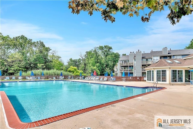 pool featuring a patio and fence