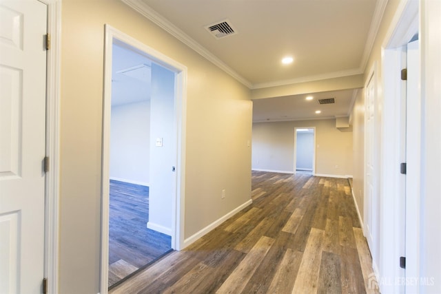 hall featuring crown molding, recessed lighting, visible vents, wood finished floors, and baseboards