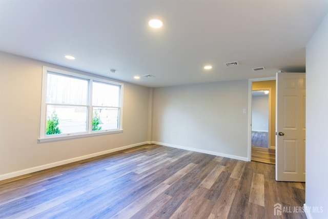 unfurnished room with recessed lighting, visible vents, baseboards, and wood finished floors