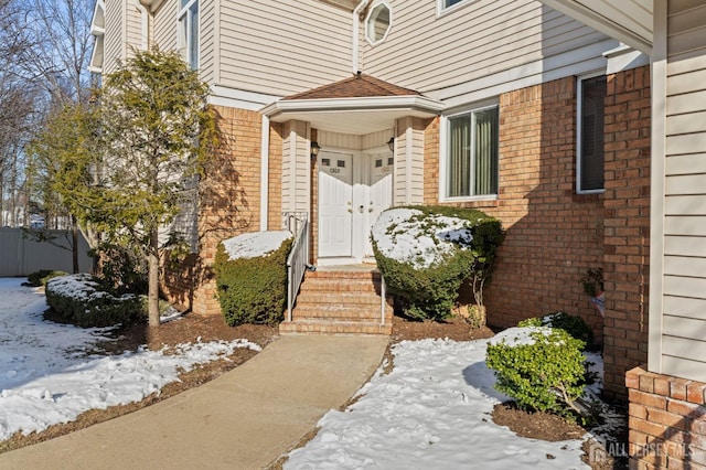 view of snow covered property entrance