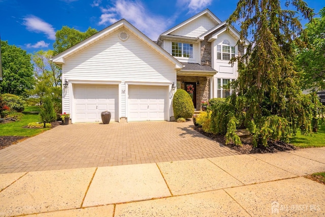 16 Baltusrol Ct, Monroe, NJ 08831 - traditional-style house featuring decorative driveway, stone siding, and an attached garage