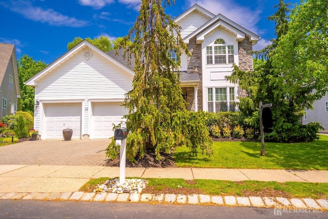 16 Baltusrol Ct, Monroe, NJ 08831 - traditional-style home with decorative driveway, a front yard, an attached garage, and stone siding