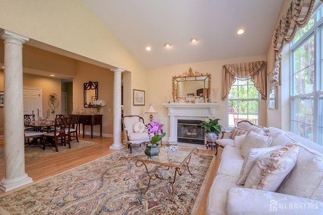 16 Baltusrol Ct, Monroe, NJ 08831 - living room with decorative columns, wood finished floors, a glass covered fireplace, recessed lighting, and high vaulted ceiling