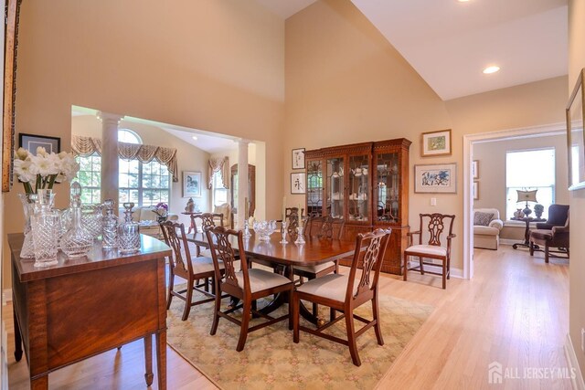 16 Baltusrol Ct, Monroe, NJ 08831 - dining space featuring ornate columns, light wood-type flooring, and a towering ceiling