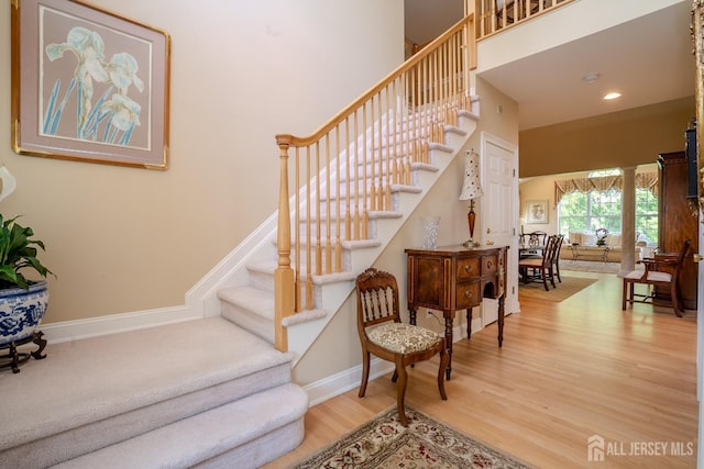 16 Baltusrol Ct, Monroe, NJ 08831 - staircase with wood finished floors, baseboards, a high ceiling, and recessed lighting