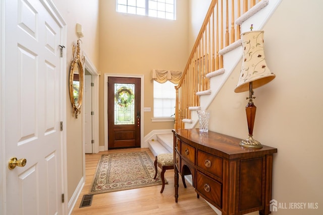 16 Baltusrol Ct, Monroe, NJ 08831 - entryway with light wood finished floors, healthy amount of natural light, stairway, a high ceiling, and baseboards