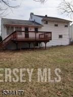 rear view of house featuring a deck