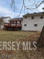 rear view of property featuring a deck
