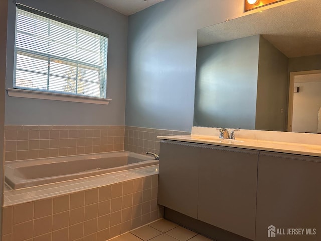 full bath featuring tile patterned flooring, a garden tub, and vanity