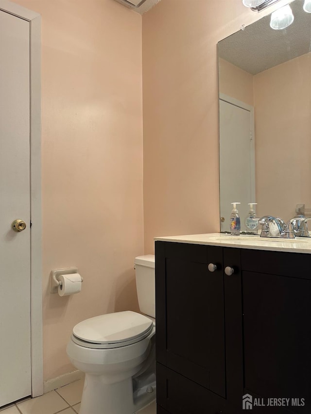 bathroom with vanity, toilet, and tile patterned floors