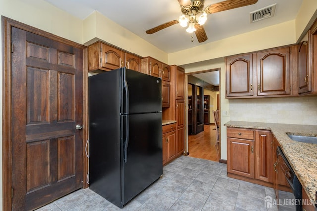 22 Roosevelt St, Pequannock, NJ 07440 - kitchen with black appliances, ceiling fan, light stone counters, and light tile patterned flooring