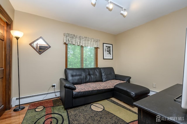 22 Roosevelt St, Pequannock, NJ 07440 - living room featuring a baseboard radiator, track lighting, and wood finished floors