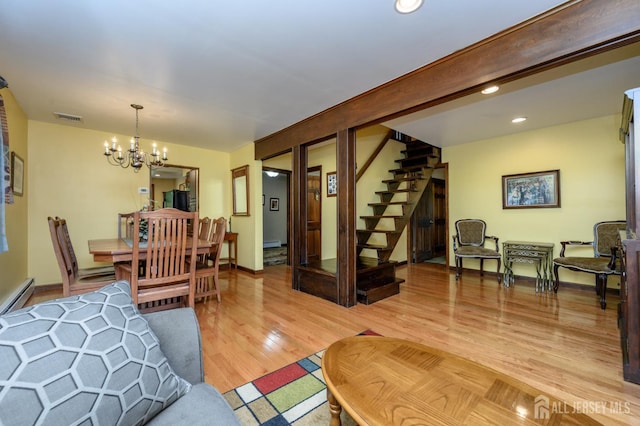 22 Roosevelt St, Pequannock, NJ 07440 - living area with a chandelier, stairs, light wood-style flooring, recessed lighting, and a baseboard radiator