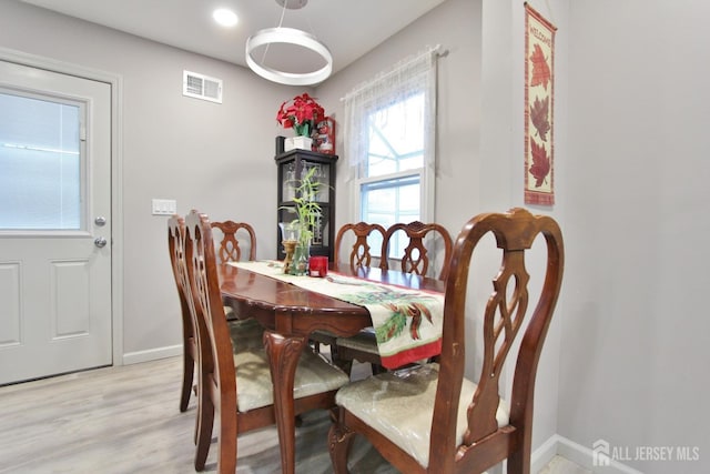 dining area with light hardwood / wood-style floors