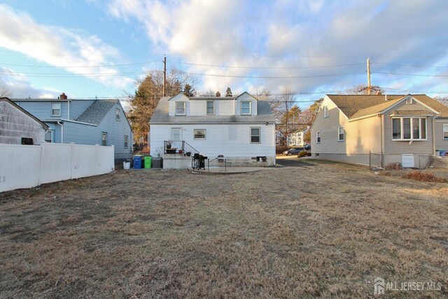 rear view of house featuring a yard