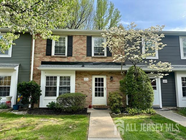 271 Constitution Cir, North Brunswick, NJ 08902 - view of front facade featuring brick siding and a front lawn