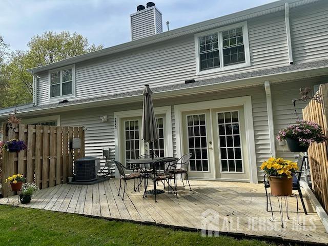 271 Constitution Cir, North Brunswick, NJ 08902 - rear view of property featuring french doors, a wooden deck, a chimney, and outdoor dining area