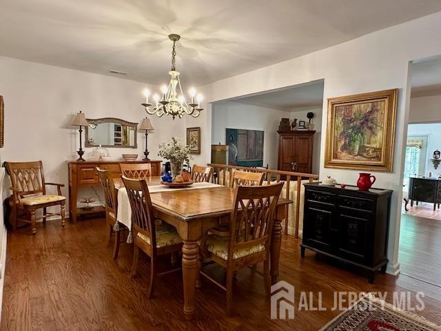 271 Constitution Cir, North Brunswick, NJ 08902 - dining space with a chandelier and dark wood-type flooring