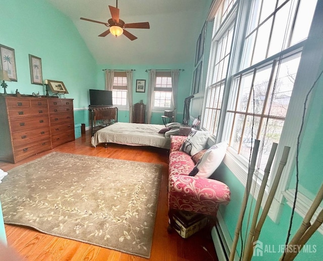 121 Beech St, Fords, NJ 08863 - bedroom featuring wood finished floors, a baseboard heating unit, high vaulted ceiling, and a ceiling fan