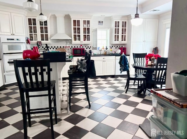 121 Beech St, Fords, NJ 08863 - kitchen with wall chimney exhaust hood, tile patterned floors, dark countertops, backsplash, and crown molding