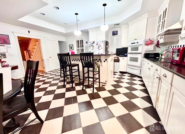 121 Beech St, Fords, NJ 08863 - kitchen featuring a tray ceiling, dark floors, dark countertops, a warming drawer, and crown molding