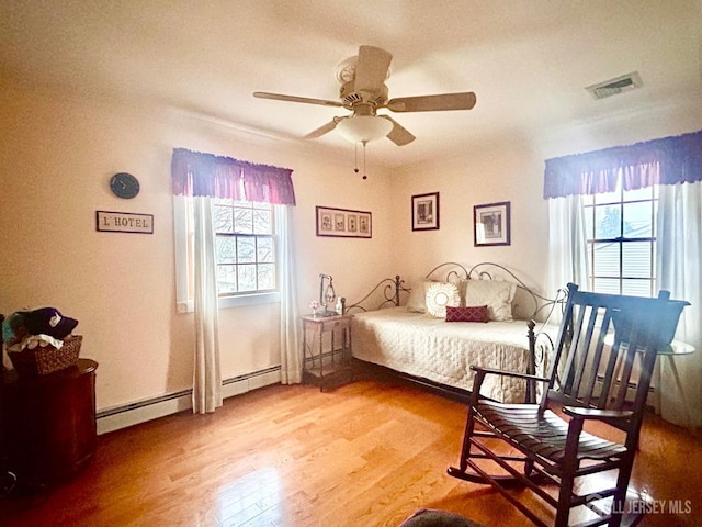 121 Beech St, Fords, NJ 08863 - bedroom featuring wood finished floors, a baseboard radiator, and ceiling fan