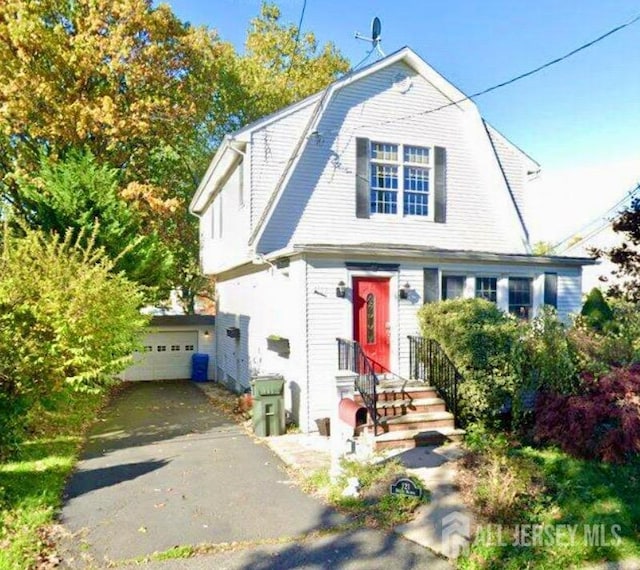 dutch colonial with driveway and a gambrel roof