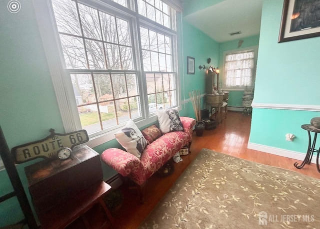121 Beech St, Fords, NJ 08863 - living area with wood finished floors, baseboards, and a baseboard heating unit