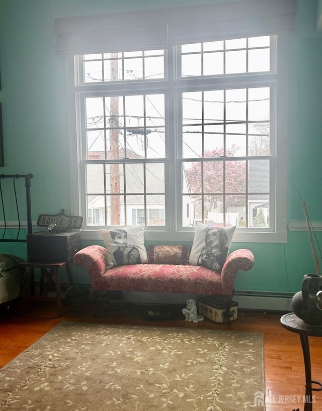 121 Beech St, Fords, NJ 08863 - sitting room featuring a baseboard radiator, wood finished floors, and plenty of natural light