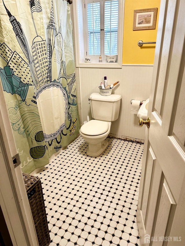 121 Beech St, Fords, NJ 08863 - bathroom with a wainscoted wall, toilet, and a shower with shower curtain