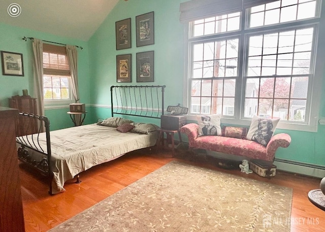 121 Beech St, Fords, NJ 08863 - bedroom featuring a baseboard radiator, vaulted ceiling, and wood finished floors