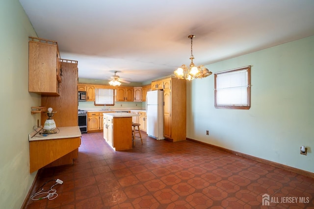 kitchen with range, a center island, white refrigerator, a kitchen bar, and decorative light fixtures