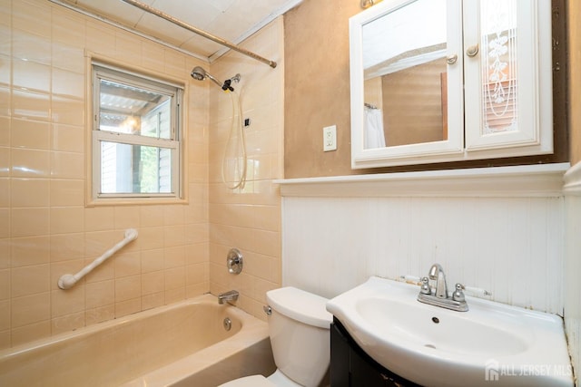 full bathroom with tiled shower / bath combo, vanity, and toilet