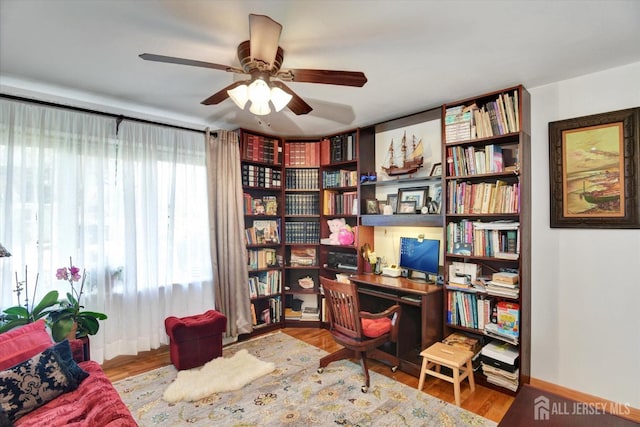 home office with a ceiling fan and wood finished floors