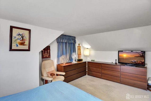 bedroom featuring light carpet and vaulted ceiling