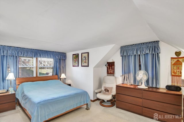bedroom featuring carpet and lofted ceiling