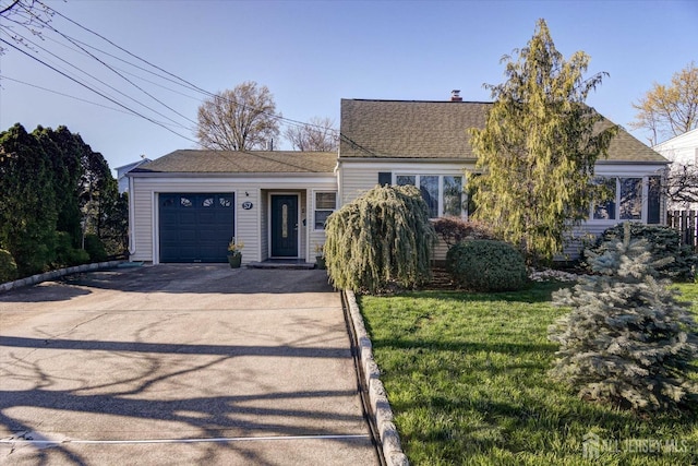 view of front of house with driveway, a garage, a front yard, roof with shingles, and a chimney