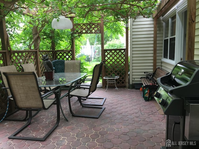view of patio with outdoor dining space and fence