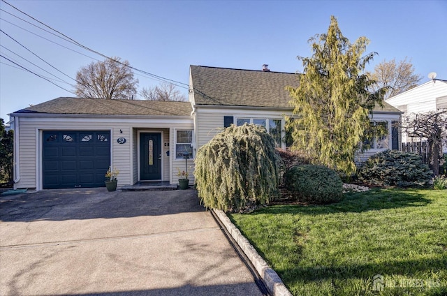 view of front of home featuring a front yard and asphalt driveway